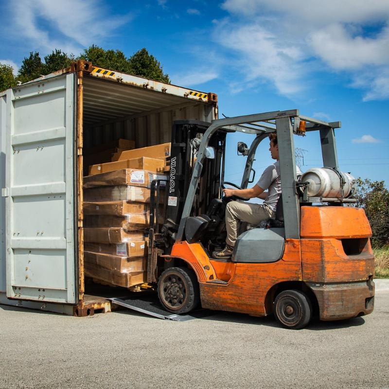 HD Ramps 48"x36" Grit-Coat Shipping Container Ramps is in use by a forklift

