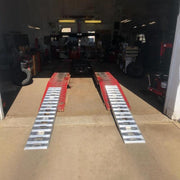 HD Ramps 8' Lay-Over Auto Hoist Ramp Extensions is placed on the riser
