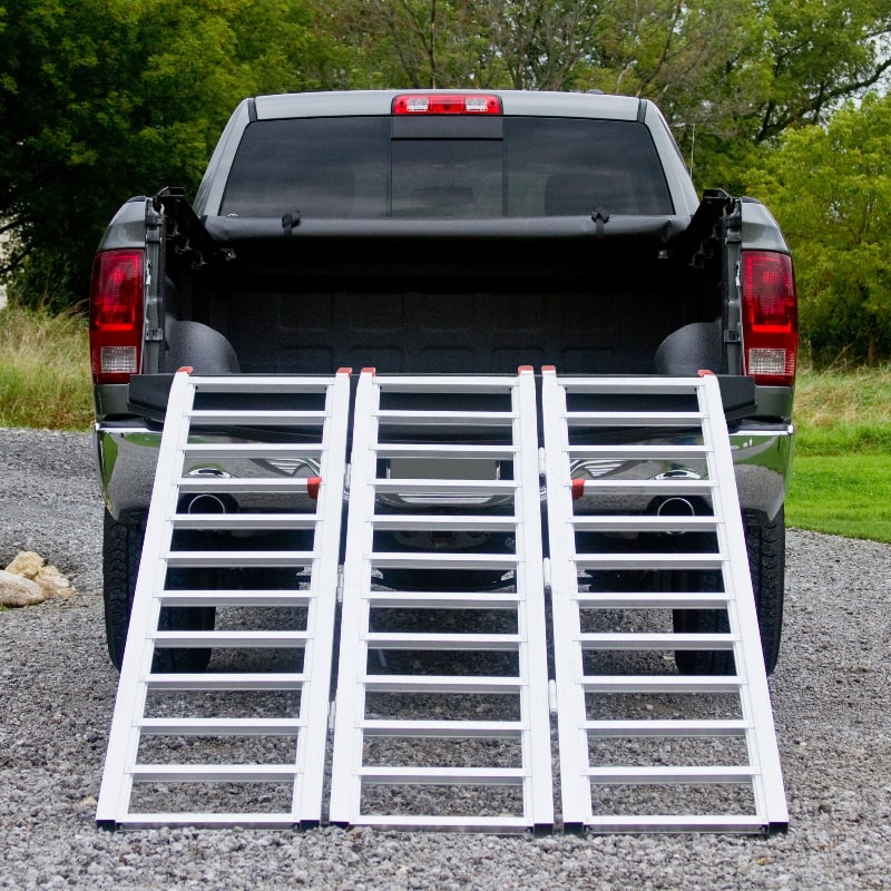 Black Widow Aluminum Extra-Wide Folding ATV Ramp mounted on the back of a truck rear view
