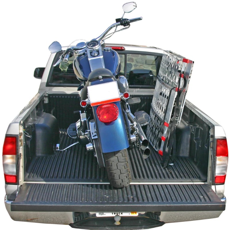 Black Widow Aluminum Folding Arched 3-Piece Motorcycle Ramp folded with motorcycle placed on the back of a pickup truck