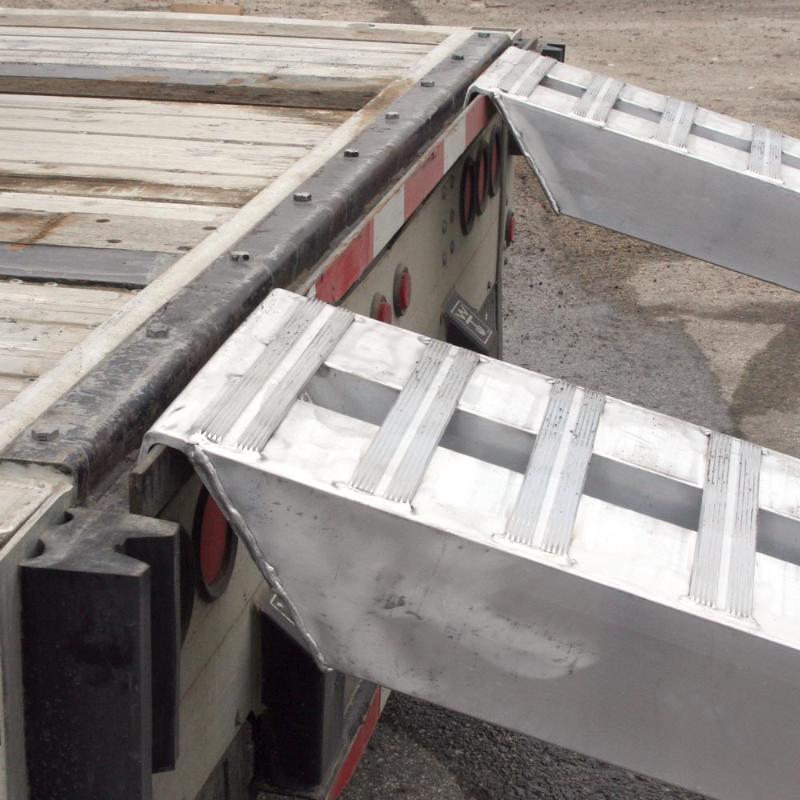 HD Ramps Hook-End Heavy Equipment Ramps 12'x16" with 12,000 lbs Capacity is hooked to the trailer