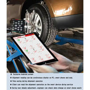 Technician reading Katool KT-AV651 alignment data on a tablet at the wheel