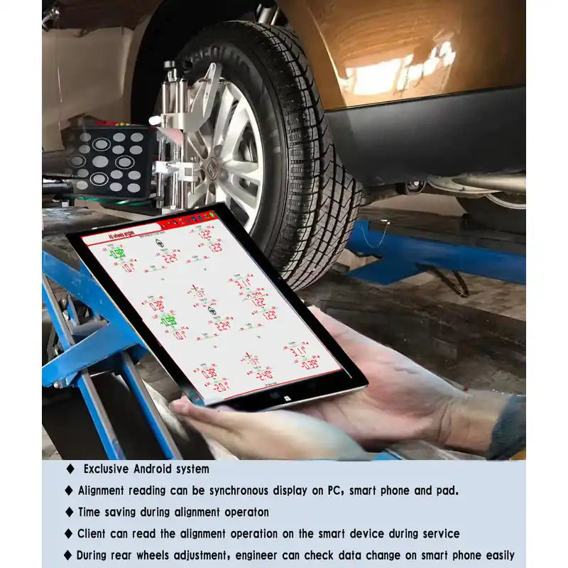 Technician reading Katool KT-AV651 alignment data on a tablet at the wheel