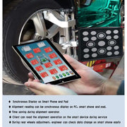 Technician reading Katool AV9 Pro alignment data on a tablet at the wheel