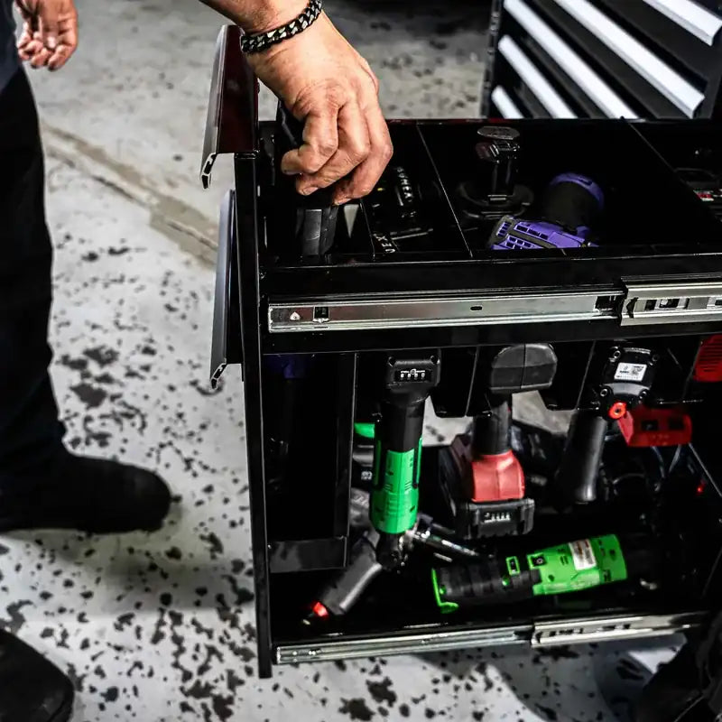 Tech reaching into the top of the Juic'd Box power drawer