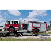 HD Ramps step deck ramp system loads a large fire truck onto a semi-trailer.