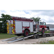 HD Ramps side view shows the modular system loading a heavy fire truck onto a trailer.