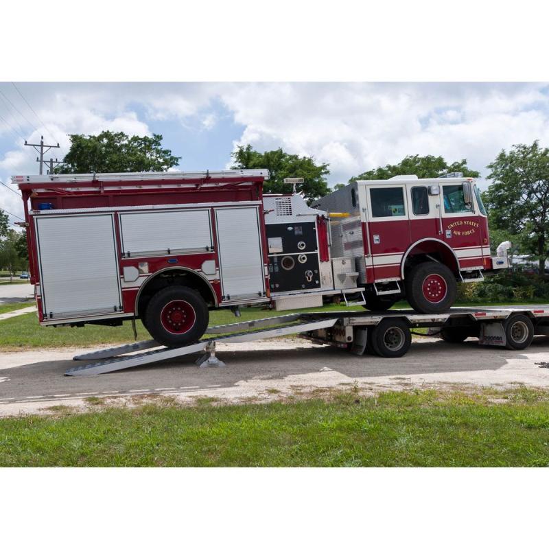 Ramp loading lifts a firetruck onto a step deck trailer using the HD Ramps aluminum bunk ramp kit.
