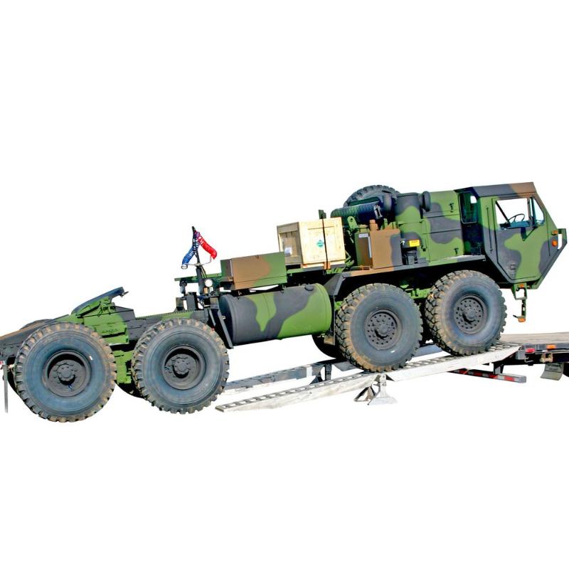 HD Ramps modular ramp system loads a heavy-duty military truck onto a step deck trailer.