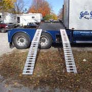 HD Ramps aluminum folding smart car ramps are securely attached to the side of a trailer.
