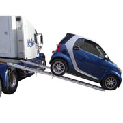 HD Ramps aluminum folding car ramps are used to safely unload a Smart Car from a flatbed trailer.