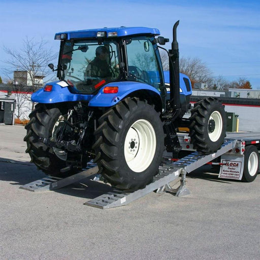 HD Ramps 4 Ramp Master Kit (SKU: 20-16-192-02-02-MLL-4-KIT) is actively loading a tractor onto a 16-inch step deck trailer.