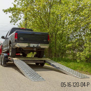 HD Ramps EZ Traction aluminum car ramps are attached to a trailer carrying a pickup truck load.