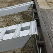HD Ramps aluminum hook-end car trailer ramp securely attached to the trailer rub rail.