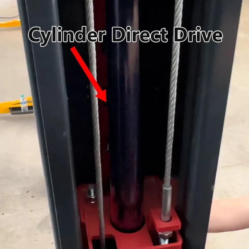 Overhead two-post car lift from KATOOL showing the direct-drive hydraulic cylinder for smooth, even lifting power.