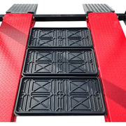 Four post storage lift from Katool showing the oil pan positioned on the platform for vehicle maintenance and service.