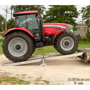 HD Ramps 20,000 lb. modular ramp system is used to safely load a large tractor onto the trailer.