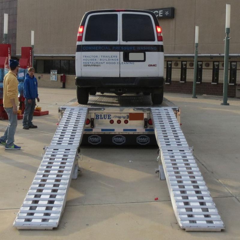 HD Ramps 20,000 lb. modular ramp system is used to safely load a commercial van onto the trailer.