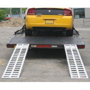 HD Ramps aluminum plate-end trailer ramps shown attached to a trailer with a car loaded.