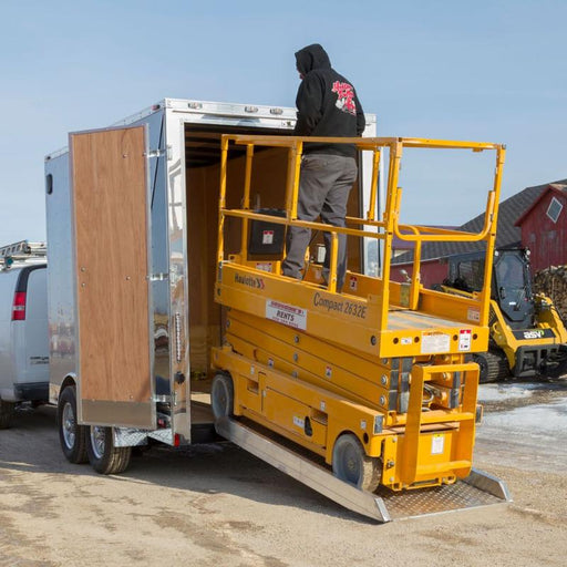 Scissor lift being loaded onto the trailer using he HD Ramps scissor lift ramp.