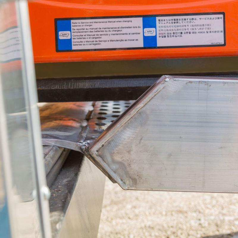 HD Ramps plate-end scissor lift ramp is shown securely attached to the edge of the trailer.