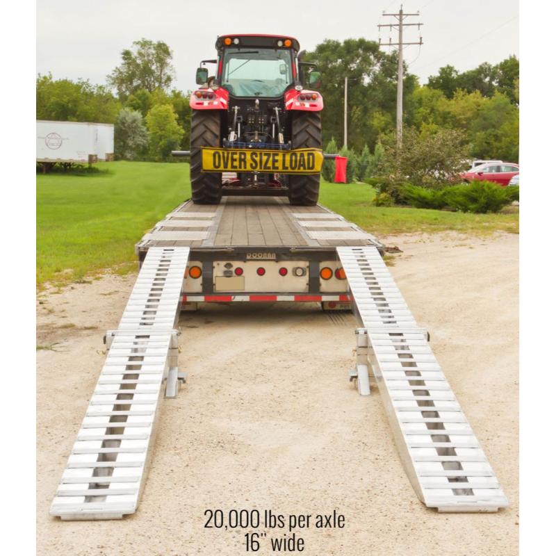 HD Ramps modular ramp system successfully loaded the large tractor onto the bed of the step deck trailer.